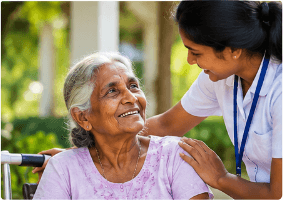 A Careway care coordinator smiling warmly with an elderly woman in a wheelchair